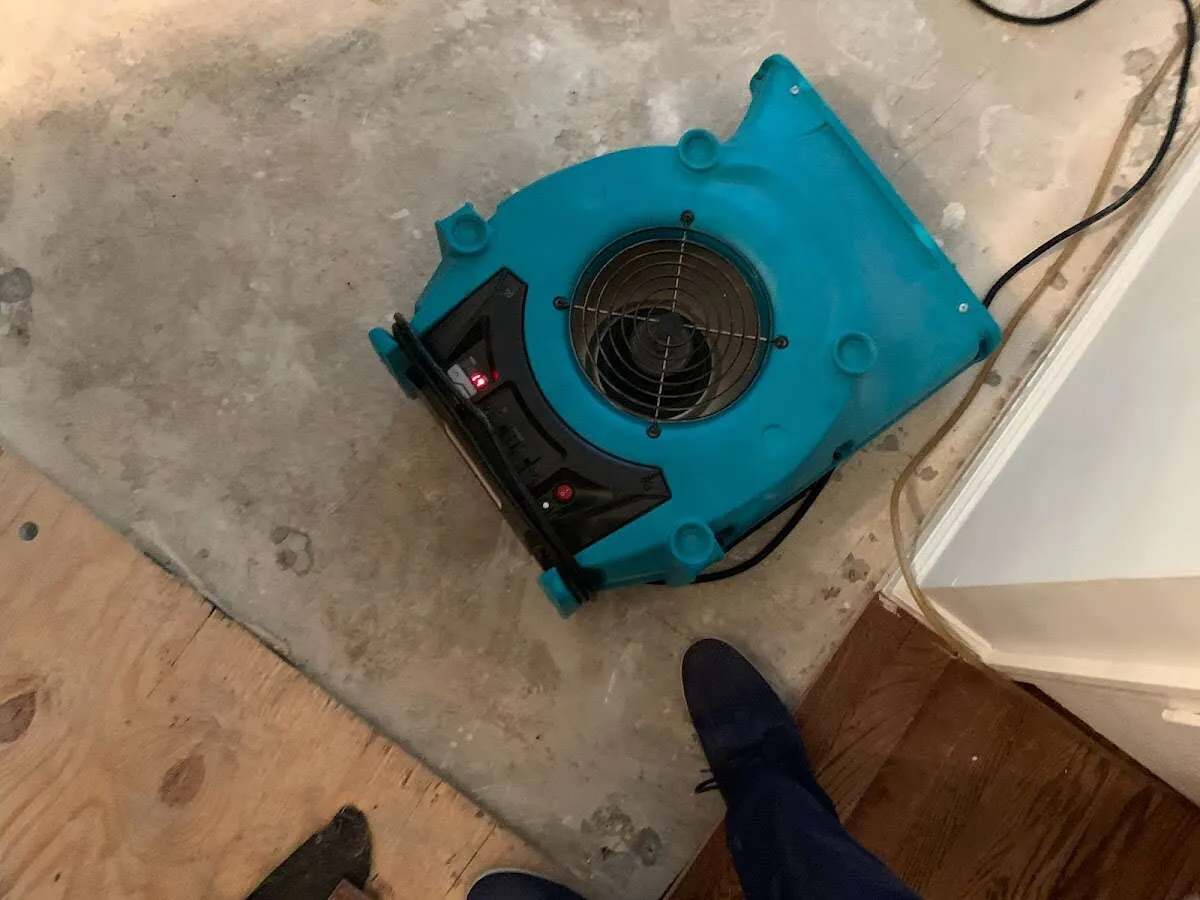 Air mover drying subfloor during Commercial Water Damage Restoration in Winnemucca